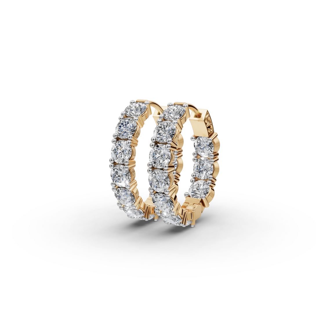 Gold hoop earrings with diamond accents on a white background
